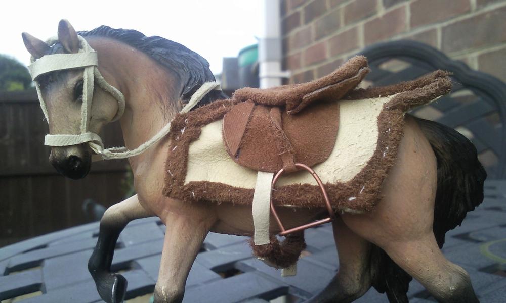 I made a complete set of tack in this particular style- this is an exercise rug made completely from leather and i used copper wire to make the shape for the saddle.