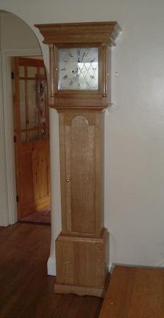 This project was completed more or less at the same time as the writing slope. The original clock case had sat aound in my Dad's garage awaiting restoration for my whole life - but he never got around to doing it. So in memory of him I decided to do the job - but by this time the case had pretty well come completely to bits. I decided to make a new one and drew up a design from what was left of the original. The hood was missing so I had to research what it may have looked like. Fortunately there is a clock restorer in Derby who was able to restore the movement. A colleague of mine,Dave Street, made a new set of weights for the clock. The new case is made from Oak.
