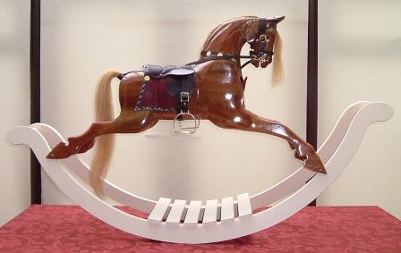 This is a half sized carousel horse - again the design is by Anthony Dew. This horse has all of the tack, mane and details carved into the wood. Painted for me by my Mother.